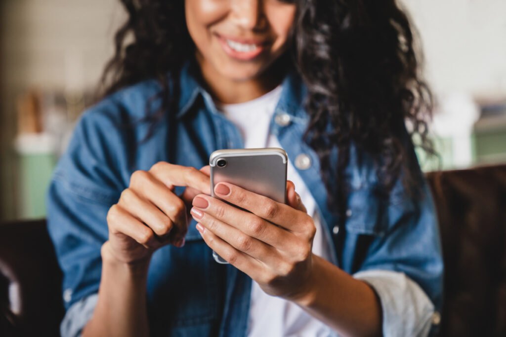 Woman looking at a cosmetic surgeon's social media profiles on her phone